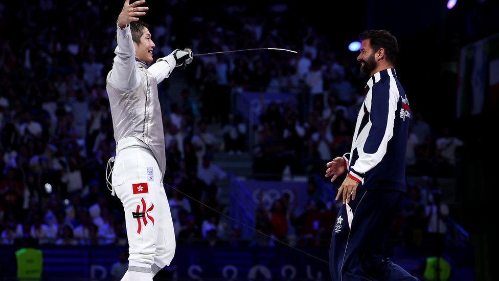 PARIS, FRANCE - JULY 29: Ka Long Cheung of team Hong Kong celebrates with his coach after winning the Fencing Men's Foil Individual Gold Medal Bout on day three of the Olympic Games Paris 2024 at Grand Palais on July 29, 2024 in Paris, France. (Photo by Al Bello/Getty Images)