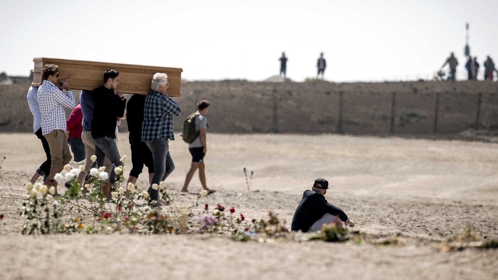 People attend a funeral of Joost and Sander, two of the surfers who died on 11 May, at the beach of Scheveningen, the Netherlands, 18 May 2020