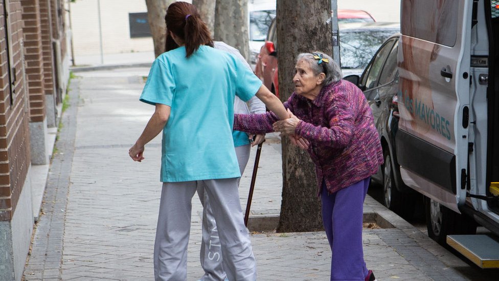 Una enfermera ayuda a una persona mayor en una casa de cuidado de ancianos en Madrid.
