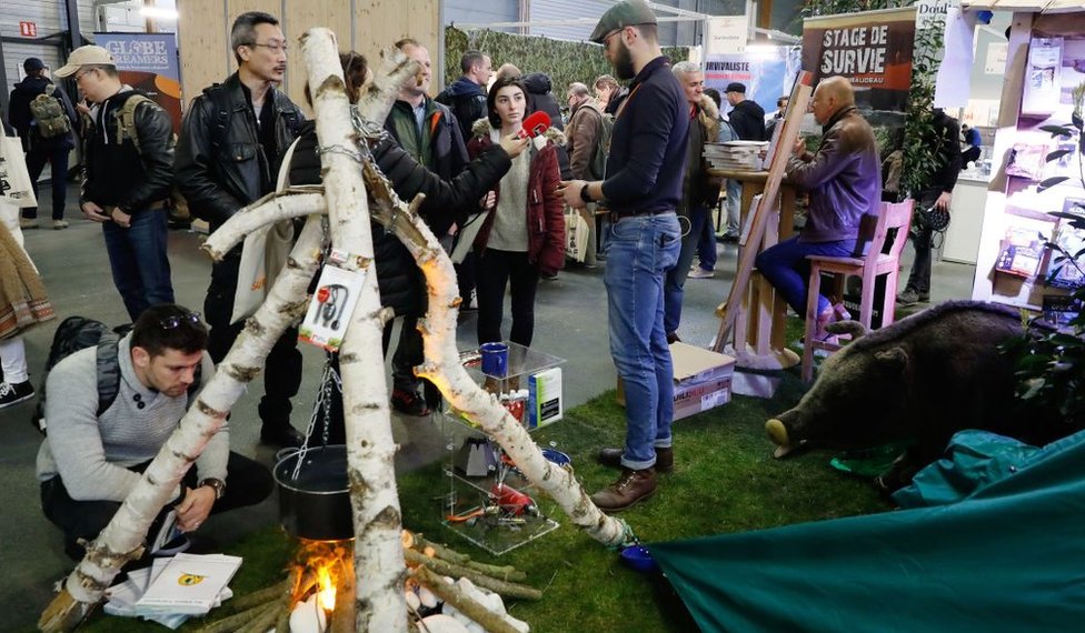 Люди посещают стенд для тренировок по выживанию на выставке Survival Expo в Париже. 23 марта 2018 г.