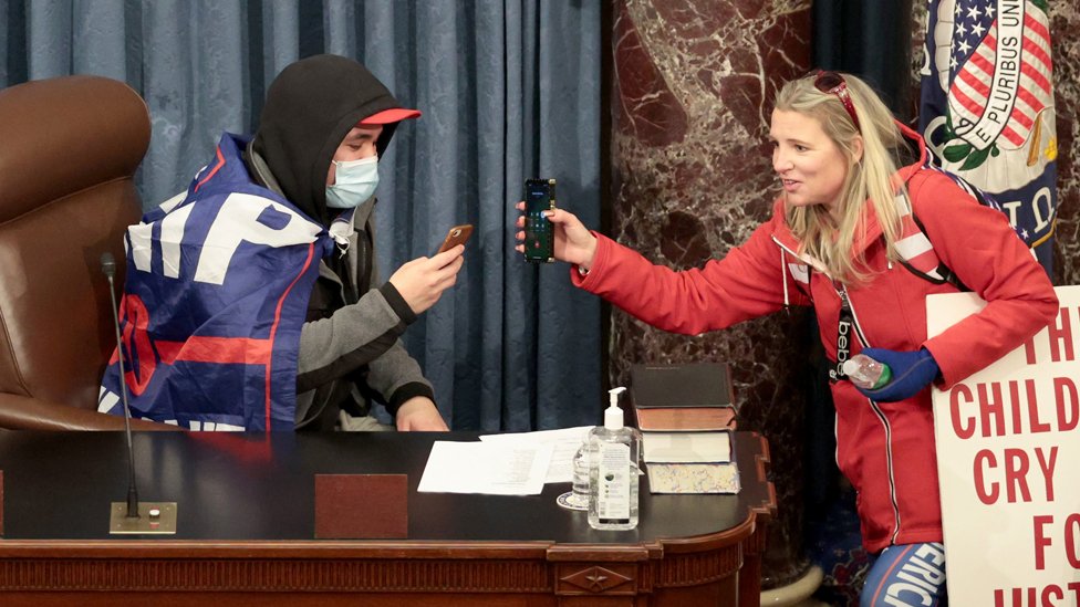 Two protesters in the US Senate chamber on 6 January