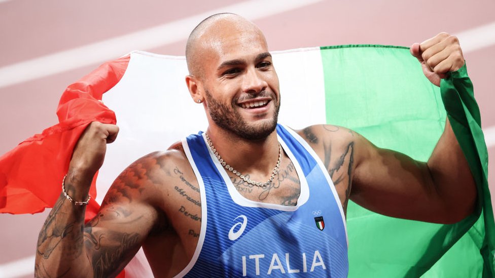 Italy's Lamont Marcell Jacobs celebrates after winning the men's 100m final during the Tokyo 2020 Olympic Games