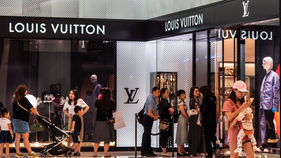 Люди выстраиваются в очередь возле магазина Louis Vuitton в торговом центре в Шэньчжэне, Китай