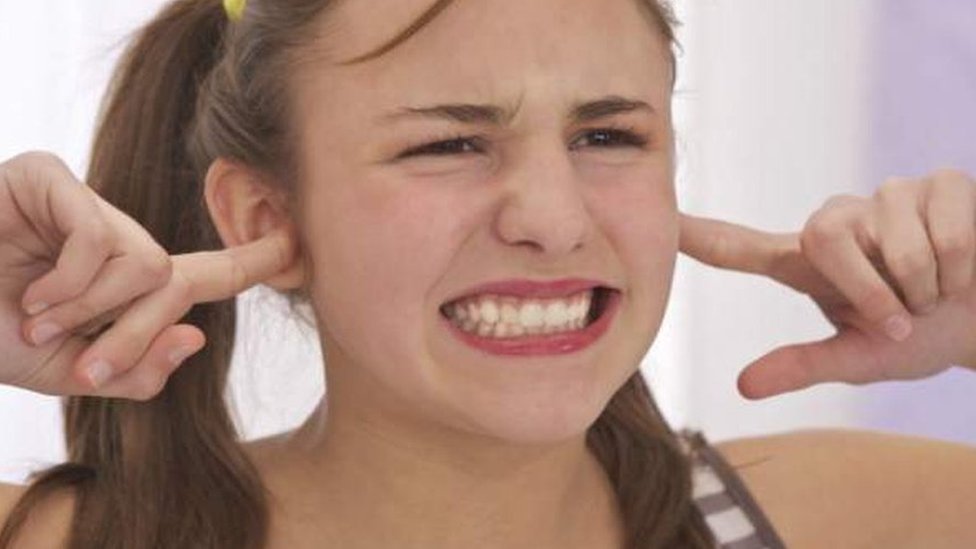 devojka drži zapušene uši