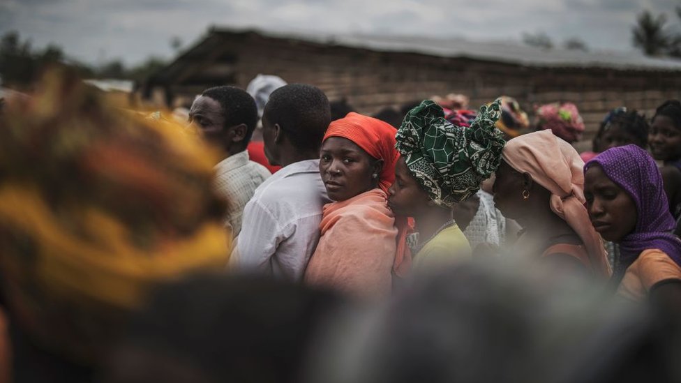 Residents gather for a distribution of utensils organised by the Catholic relief organisation Caritas in the northern Mozambique in August 2019.