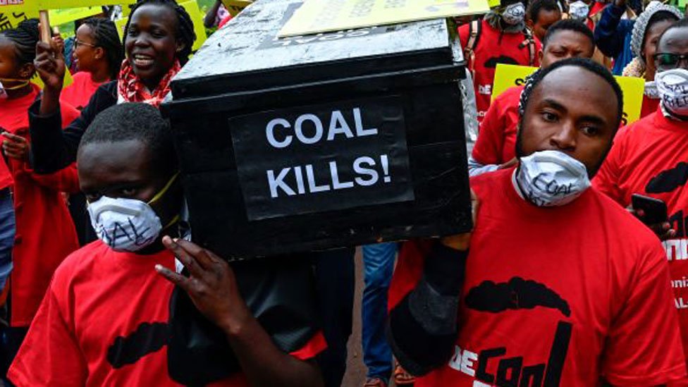 Протестующие несут гроб с надписью «уголь убивает».