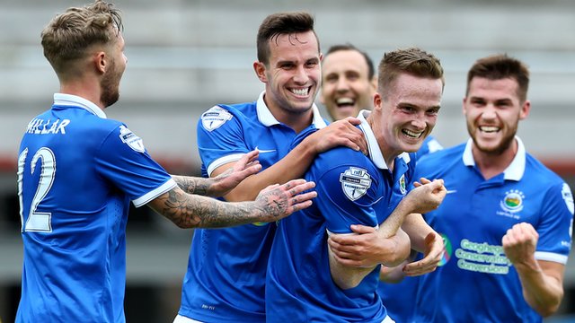 Linfield players celebrate with goalscorer Aaron Burns