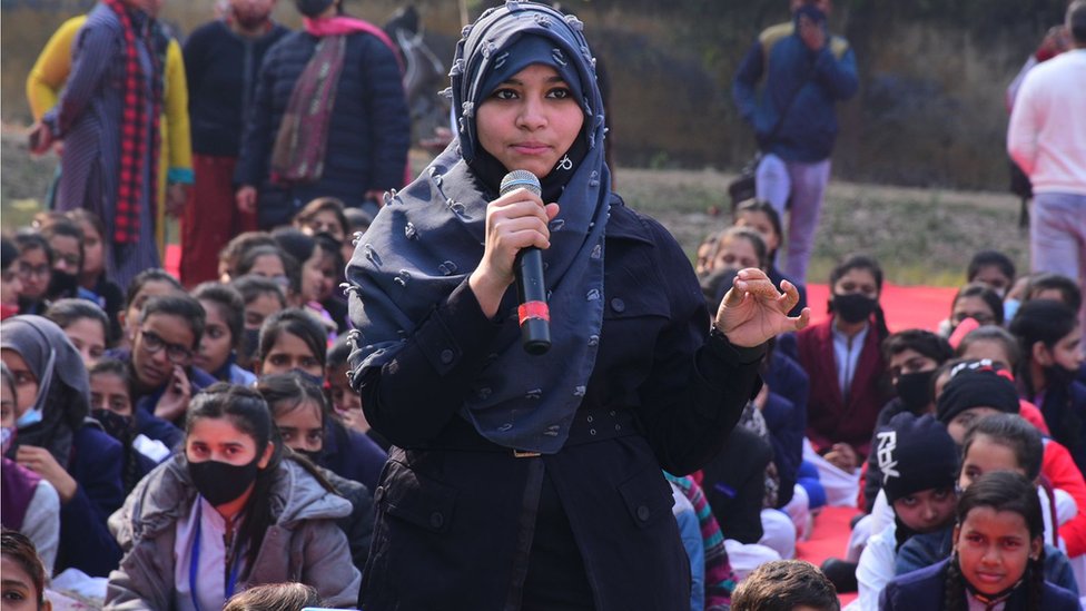 Khushnuma from Delhi expressing her views during a 'Lado Panchayat' held in Meerut with woman sitting listening in the background