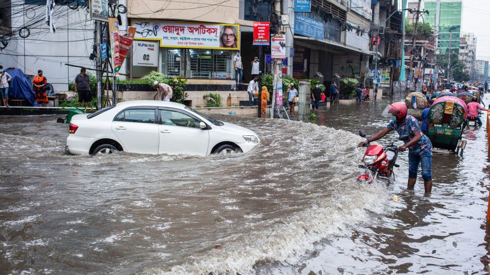 سيارة تجد صعوبة في السير عبر مياه الفيضانات في بنغلاديش