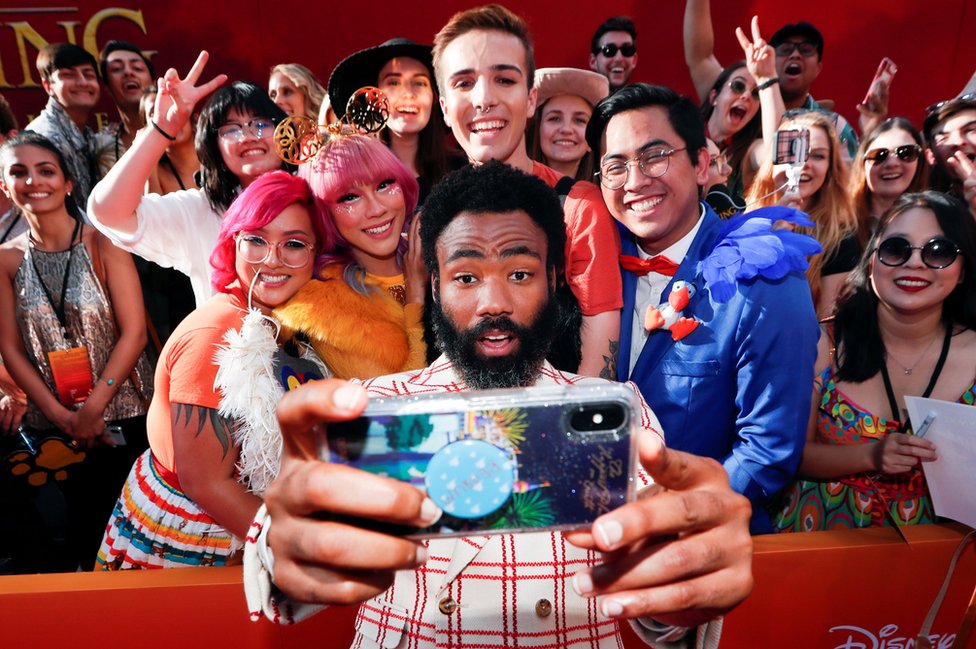 Donald Glover poses for a photo with fans