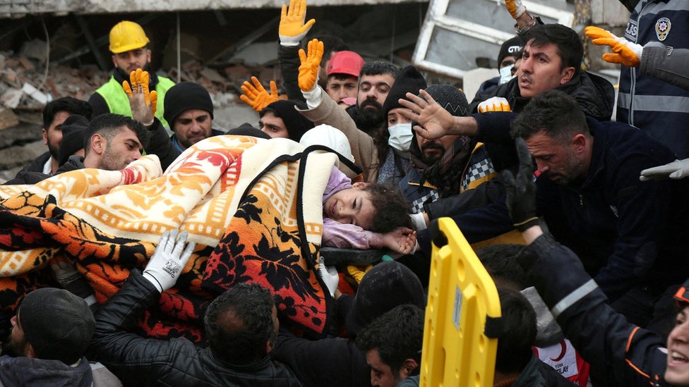 Rescuers carry out a girl from a collapsed building following an earthquake in Diyarbakir, Turkey, on 6 February 2023