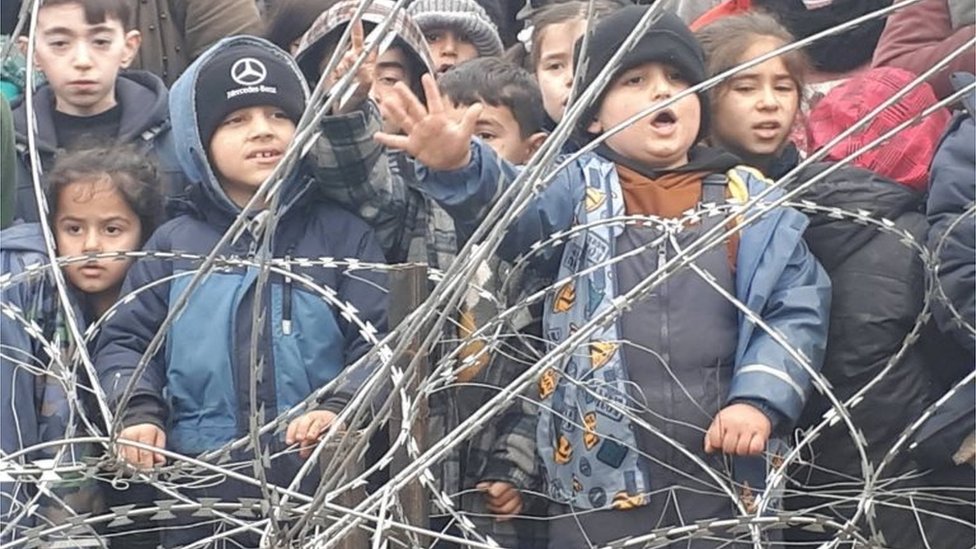 Migrant children gather near the fence on the Poland/Belarus border near Kuznica, Poland, in this video-grab released by the Polish Interior Ministry, November 11, 2021