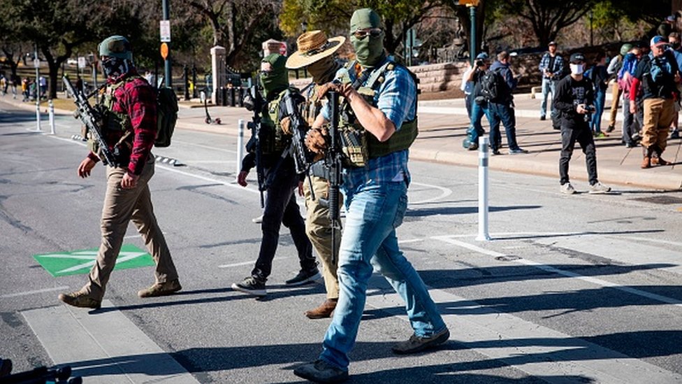 Вооруженные группы переходят улицу во время митинга перед закрытым Капитолием штата Техас в Остине, штат Техас
