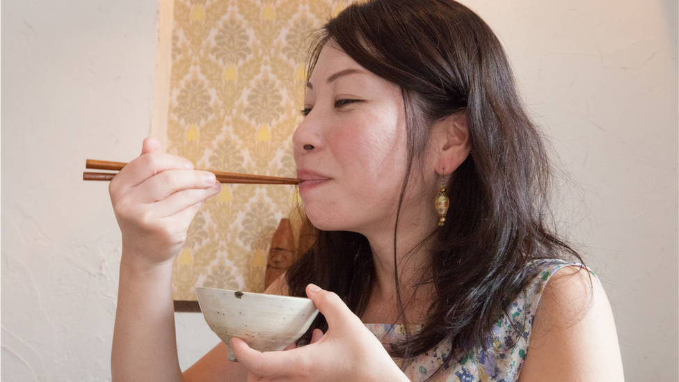 Japanese young woman eating rice