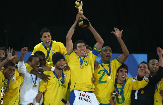Lucio lifts the 2009 Confederations Cup trophy, with an 'I Love Jesus' T-Shirt draped over his shorts