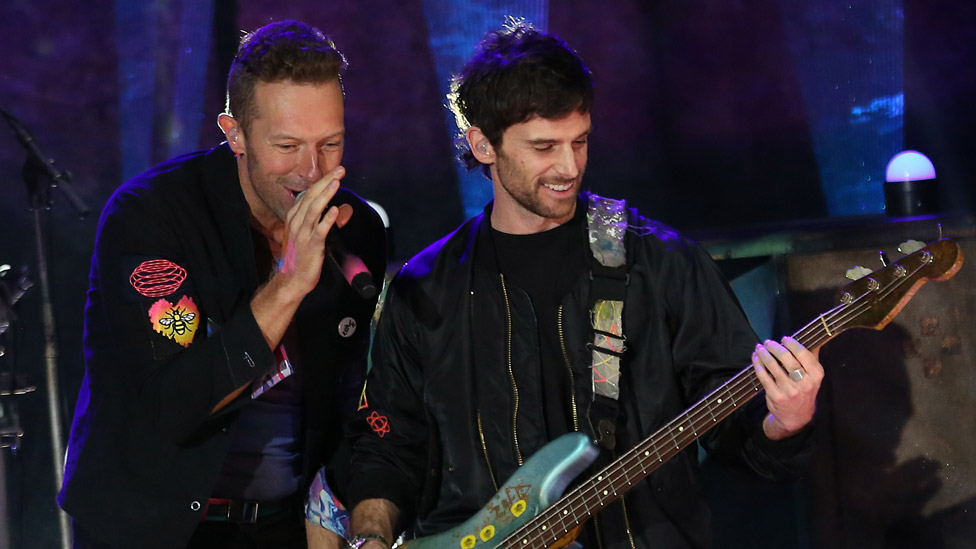 Chris Martin and Guy Berryman of Coldplay on stage in London in October 2021