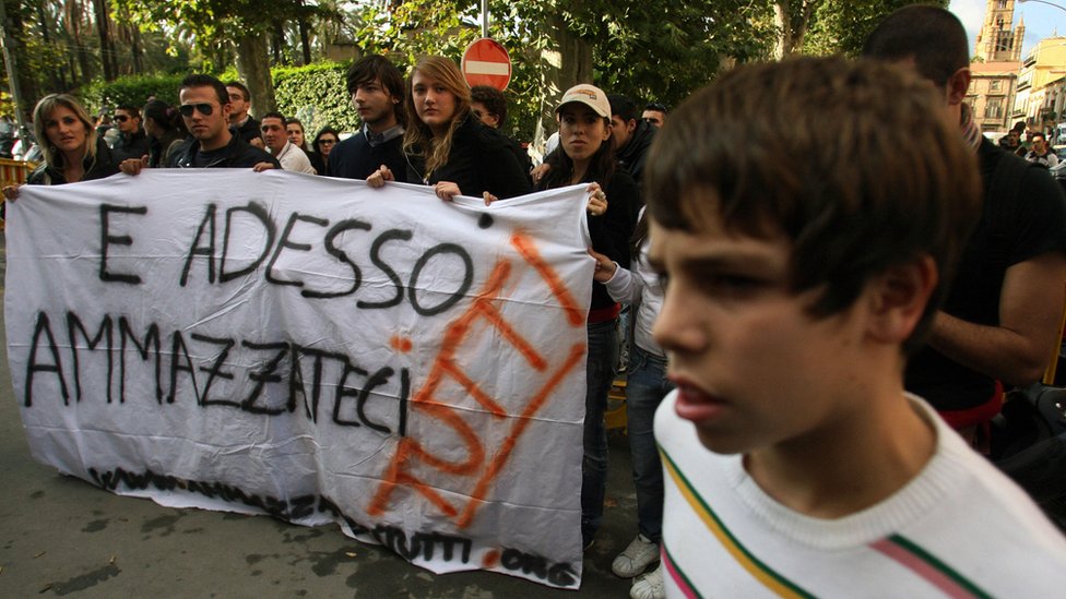 "Y ahora mátenos a todos nosotros", dice la bandera que llevan activistas anti-mafia en una protesta en 2007, en Palermo, Italia. Los activistas anti-mafia llevan una pancarta con la leyenda "Y ahora mátenos a todos nosotros"
