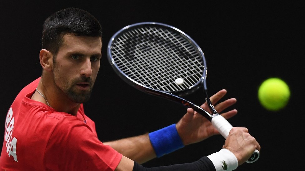 Novak Djokovic hits a volley in Davis Cup practice