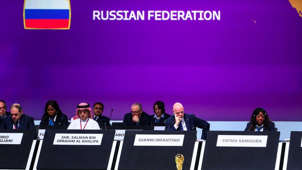 A Fifa meeting with a Russian flag in the background