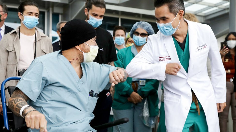 A recovering Covid patient in LA receives an elbow bump from a doctor