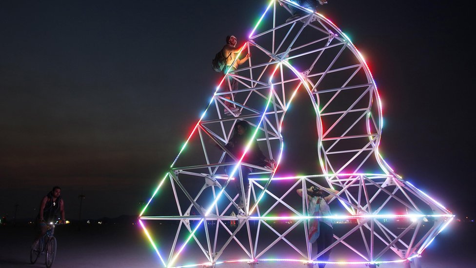 Посетители фестиваля поднимаются на арт-инсталляцию на Burning Man 2013
