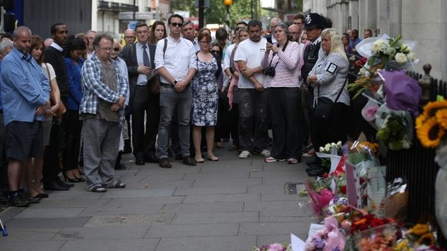 People standing at Tavistock Square memorial