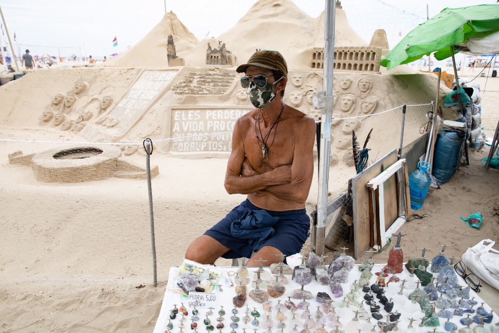 A street vendor selling figurines on the beach