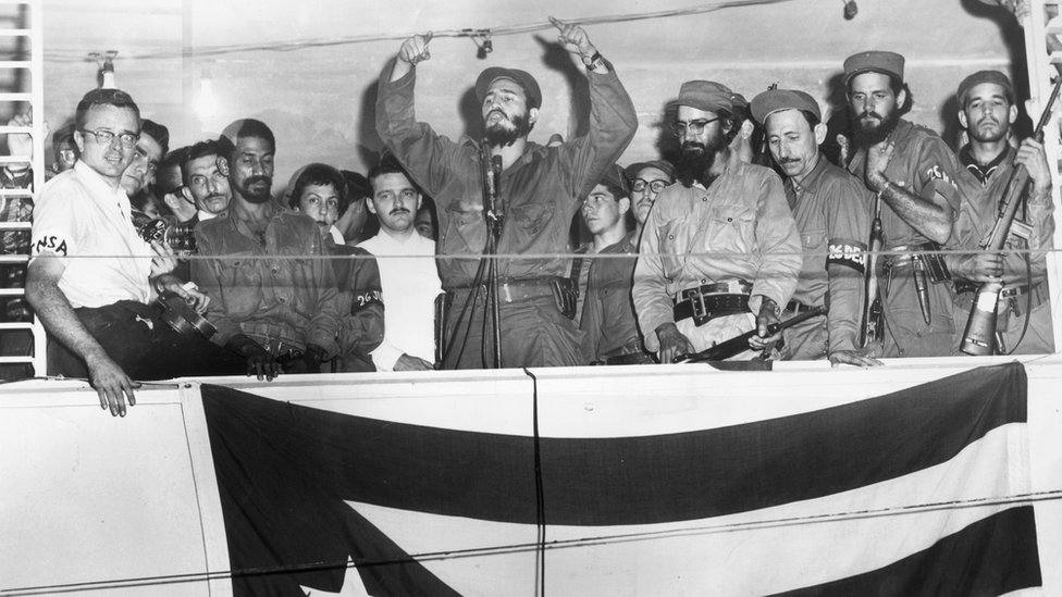 Cuban President Fidel Castro speaking from a podium to the people of Camaguey, Cuba about the Triumph of the Cuban Revolution