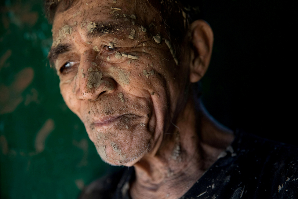 A man covered in mud in San Mateo, Rizal province, Philippines, 13 November 2020