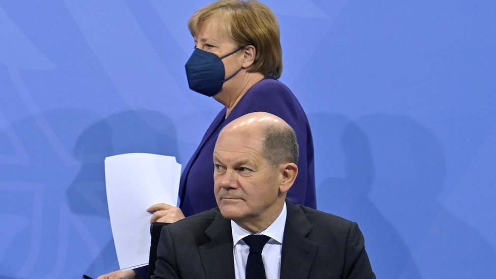 German Chancellor Angela Merkel arrives to address, together with her designated successor Olaf Scholz, a news conference following a meeting with the heads of government of Germany's federal states at the Chancellery in Berlin, Germany December 2, 2021