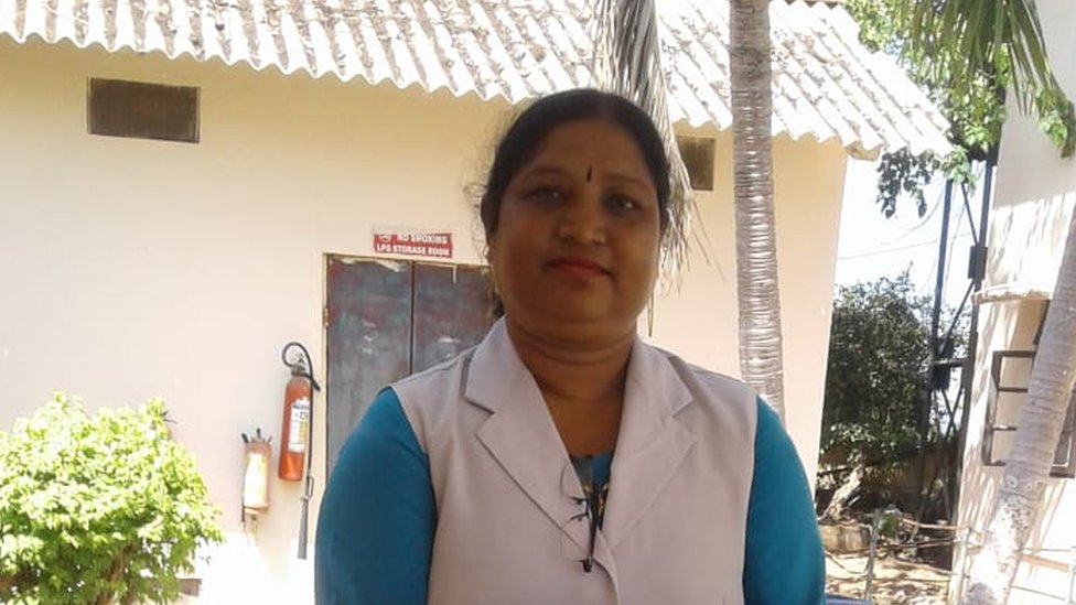 Shanti Teresa lakra standing in front of a building
