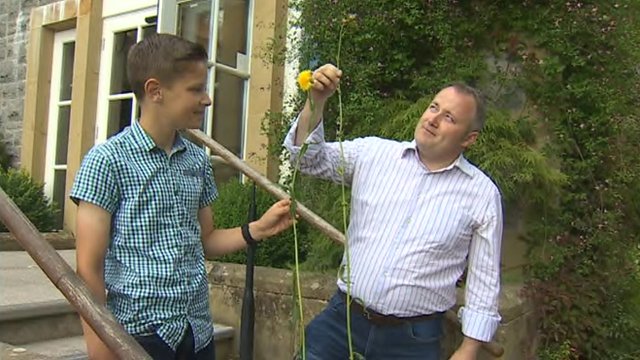 Darren Millar and son Toby with giant dandelion