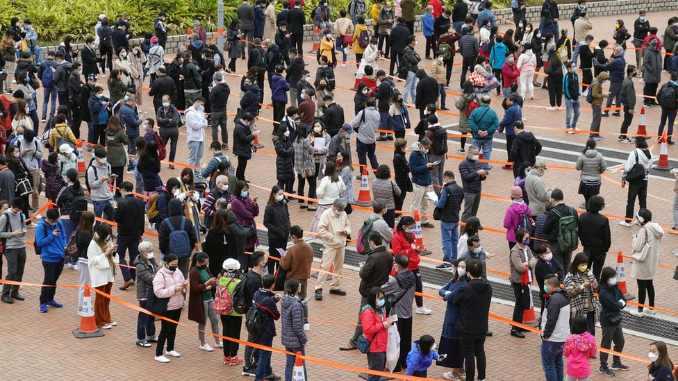 People queue at a makeshift nucleic acid testing centre for the coronavirus disease (COVID-19), at the Central district in Hong Kong, China, February 9, 2022.