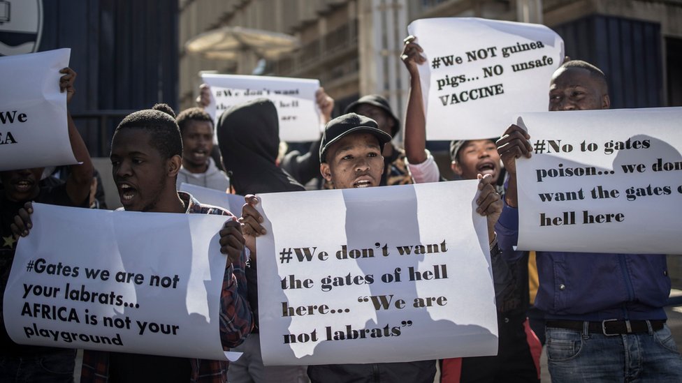 Anti-vaccination protesters in South Africa holding placards saying 