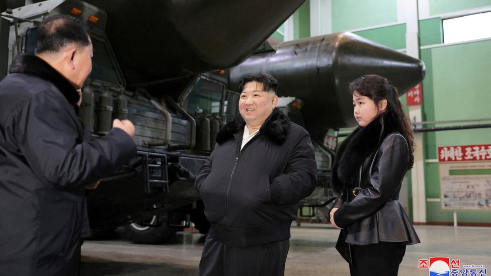 An undated photo released by the official North Korean Central News Agency (KCNA) on 05 January 2024 shows Kim Jong Un and Ju Ae inspecting a missile launcher production facility in an undisclosed location in North Korea