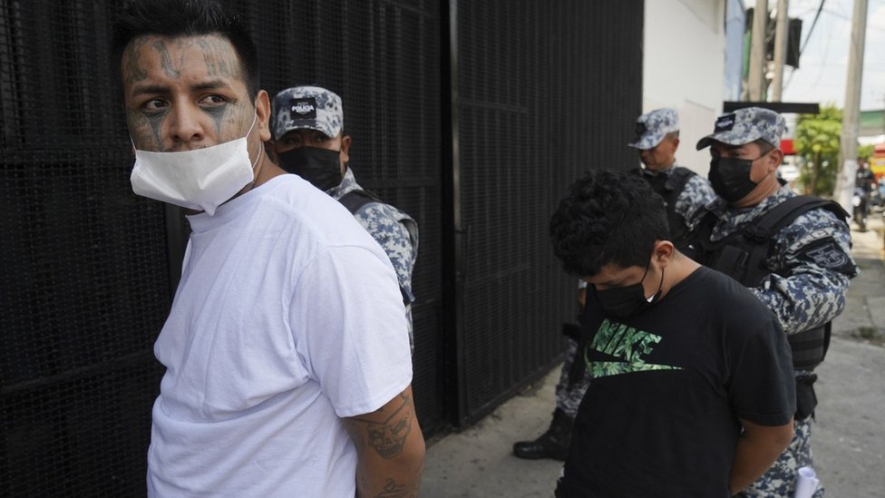 A suspect is led into a detention centre on April 25, 2022 in San Salvador, El Salvador.