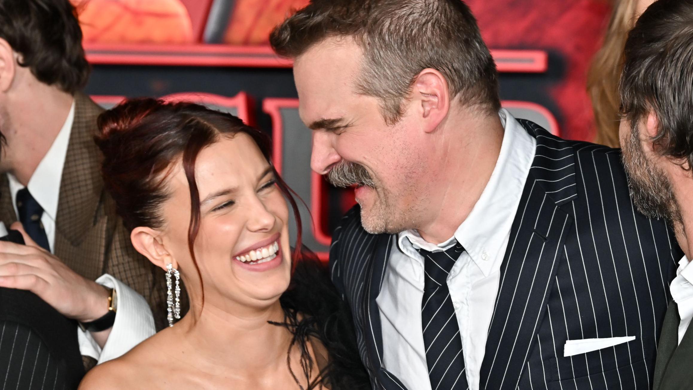Millie Bobby Brown and David Harbour embrace at Stranger Things premiere