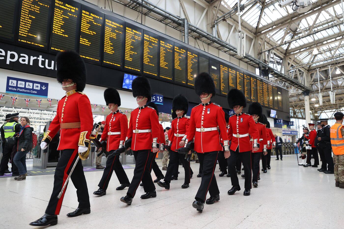 Members of the Armed Forces walk through London Waterloo station on Saturday morning