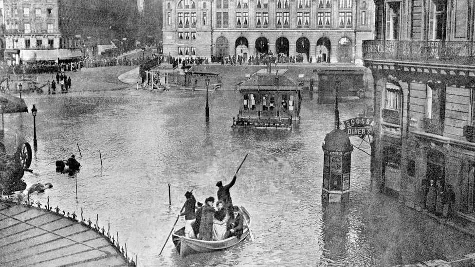 люди в лодках на воде на большой площади между ресторанами и кафе