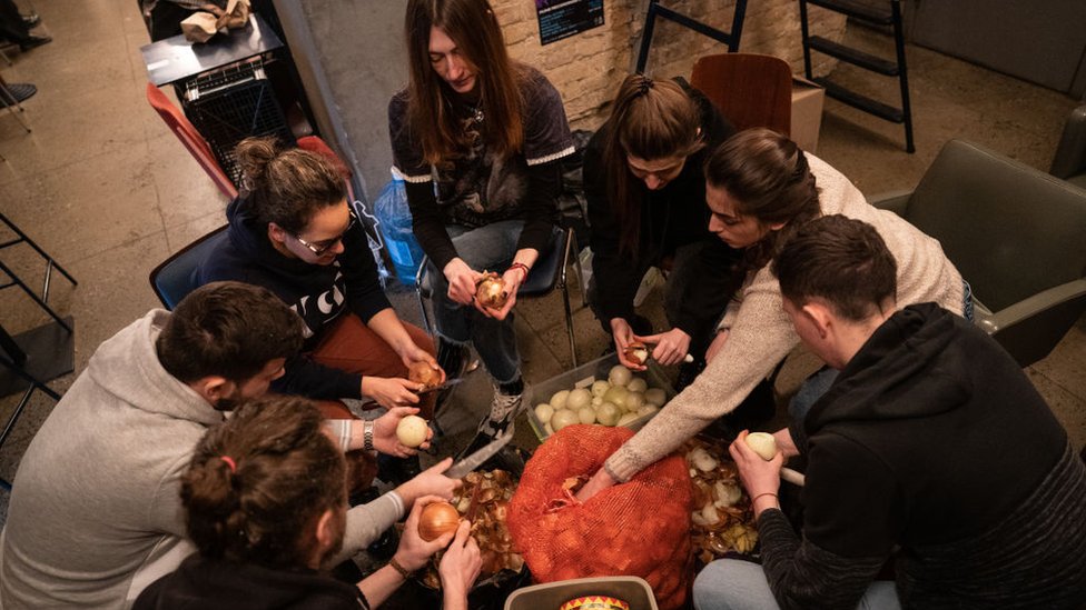 Volunteers prepare food to be distributed to soldiers in a Kyiv restaurant