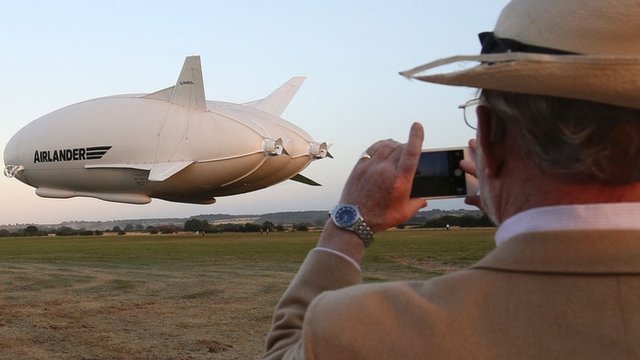 A spectator looks on as the Airlander takes off