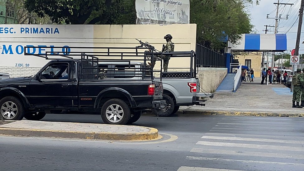 A van with an armed soldier