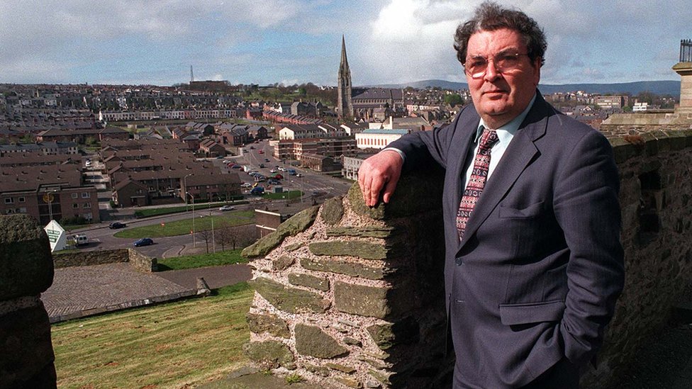 John Hume, pictured on the walls of his home city Derry