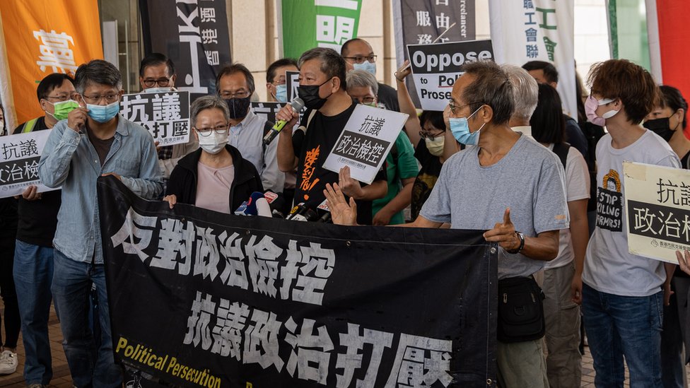 Pro-democracy activists hold banners outside the West Kowloon court buildings in Hong Kong, China, 01 April 2021. Nine democracy activists face verdict on 01 April for unauthorized assembly in August 2019. EPA/JEROME FAVRE