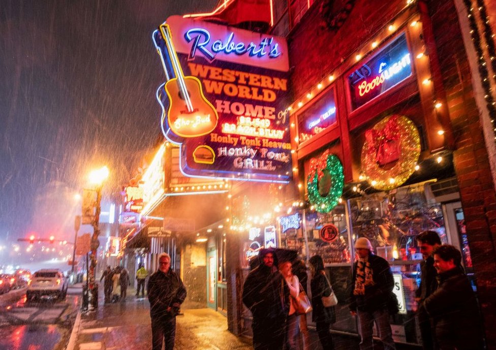 Snow falls on Broadway, a popular tourist street in Nashville, Tennessee, on 22 December 2022