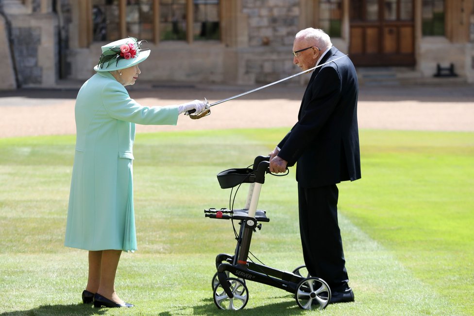 The Queen uses a sword to knight Captain Tom Moore