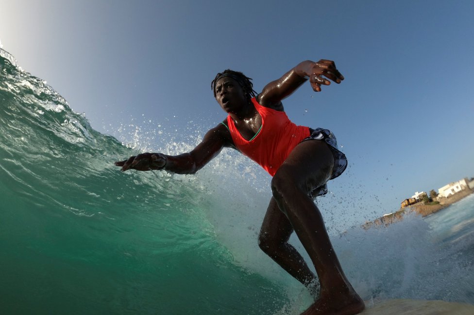 Khadjou Sambe surfs in the ocean