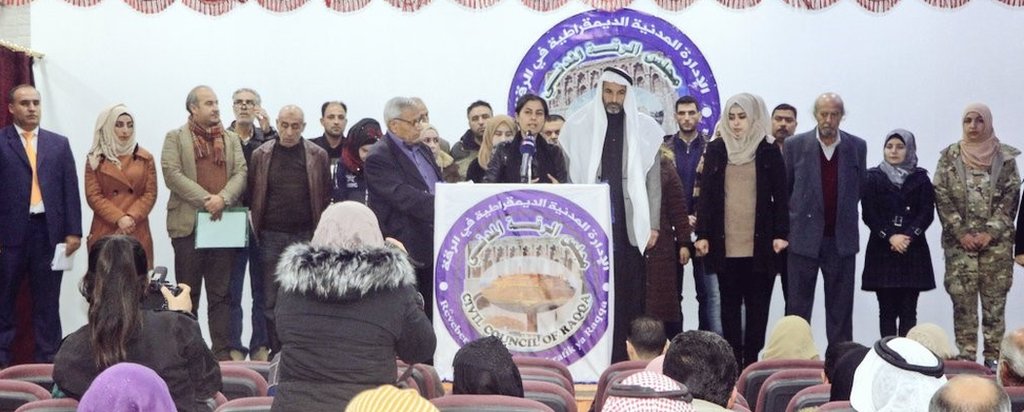 Laila Mustafa delivers a speech in front of the members of Civil Council of Raqqa