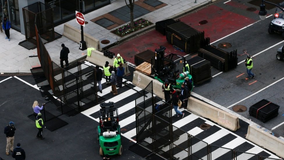 Workers place barricades to control access ahead of US President-elect Joe Biden