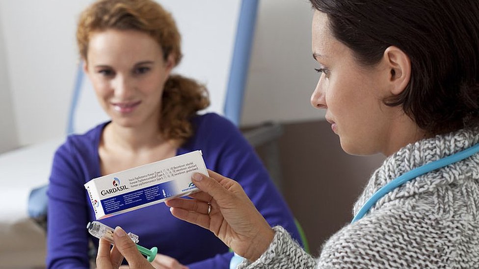 Mujer mirando una caja Gardasil